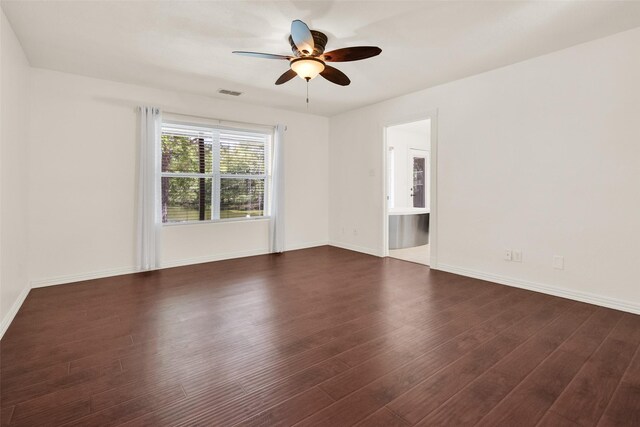 spare room with ceiling fan and dark wood-type flooring