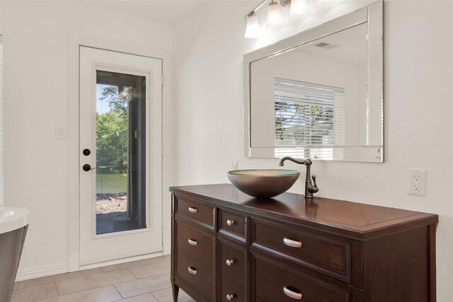 bathroom with tile patterned flooring and vanity