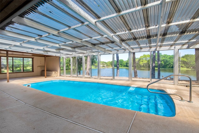 view of swimming pool featuring a water view and a patio