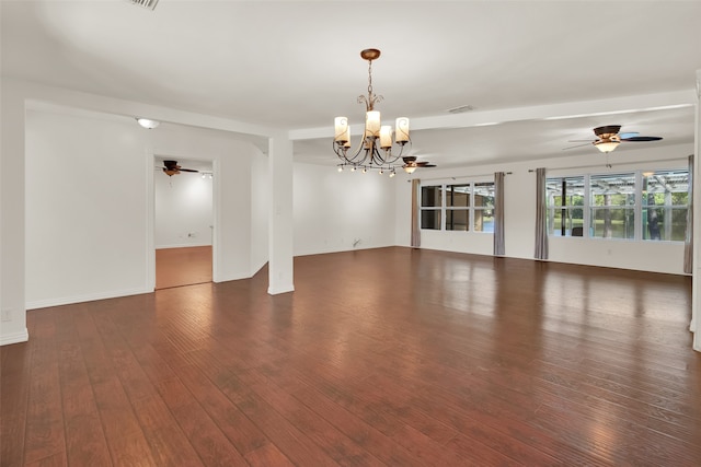 empty room with a chandelier and dark hardwood / wood-style floors