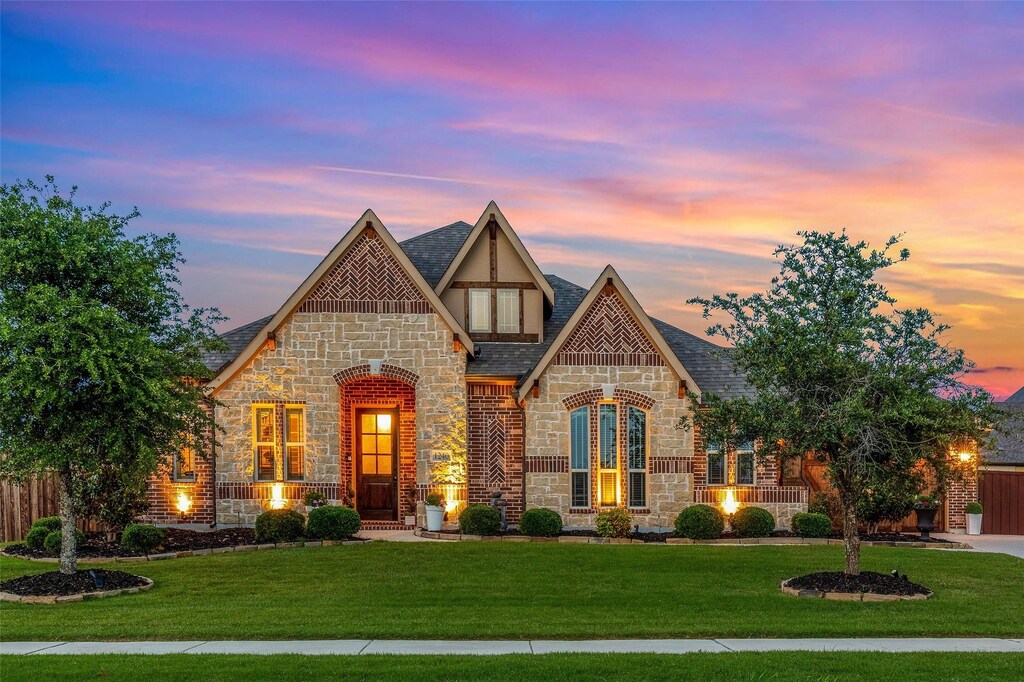 english style home with a lawn