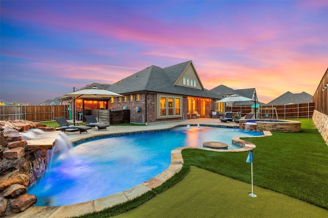 pool at dusk with an in ground hot tub, a gazebo, pool water feature, and a patio