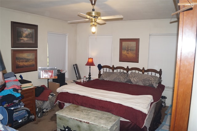 bedroom with ceiling fan, carpet floors, and ornamental molding