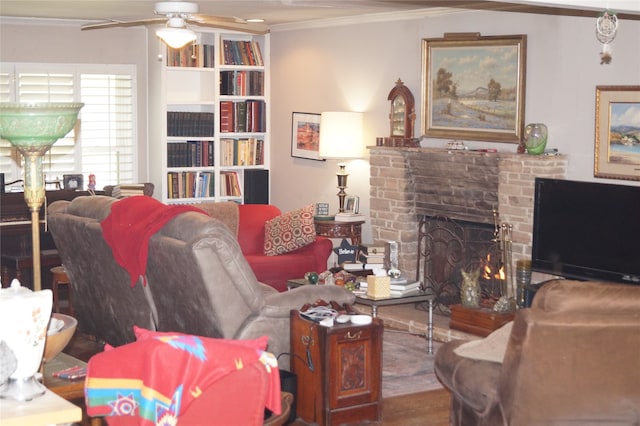 living room featuring ceiling fan, ornamental molding, hardwood / wood-style flooring, and a brick fireplace