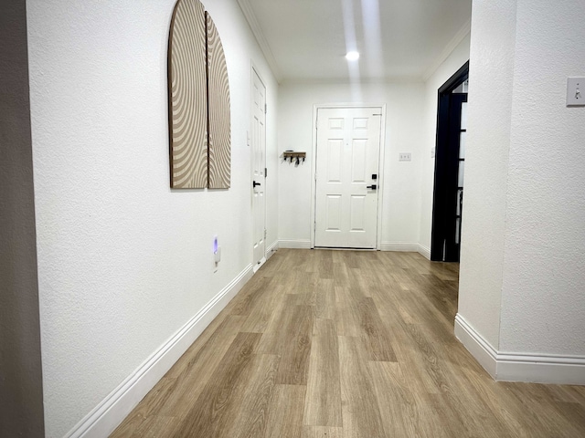 hallway with light hardwood / wood-style floors