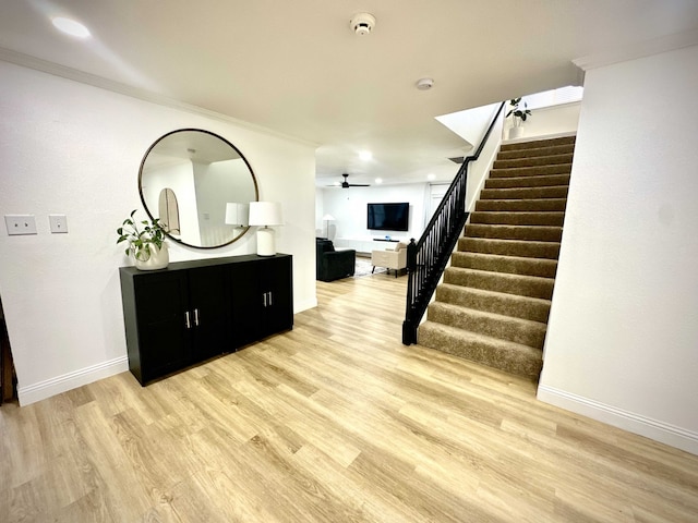 interior space with ceiling fan, ornamental molding, and hardwood / wood-style flooring