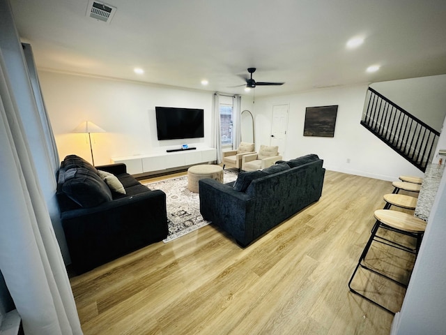 living room featuring ceiling fan and light wood-type flooring