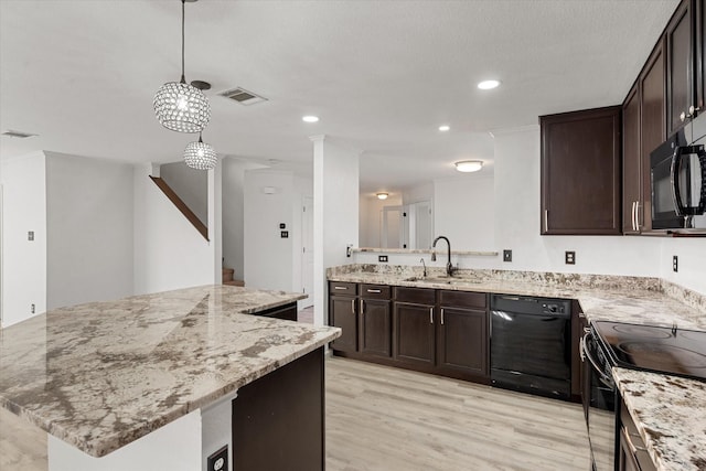 kitchen featuring a kitchen island, sink, hanging light fixtures, black appliances, and light wood-type flooring