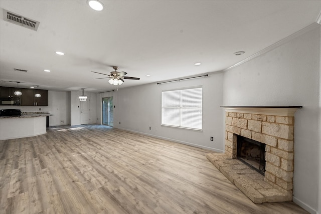 unfurnished living room featuring a fireplace, plenty of natural light, and light hardwood / wood-style flooring