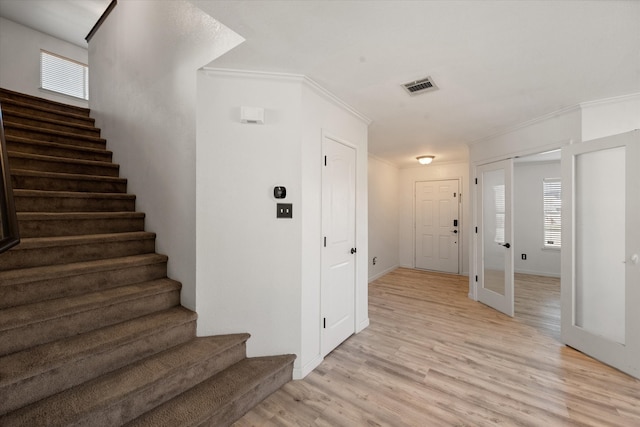 laundry room featuring hookup for an electric dryer, hookup for a washing machine, and light hardwood / wood-style flooring