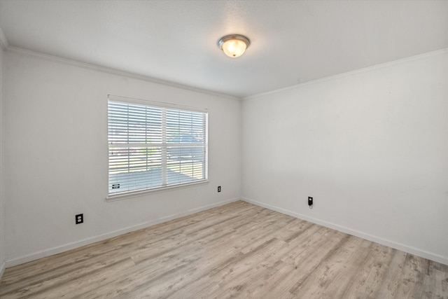 unfurnished room with crown molding and light hardwood / wood-style flooring