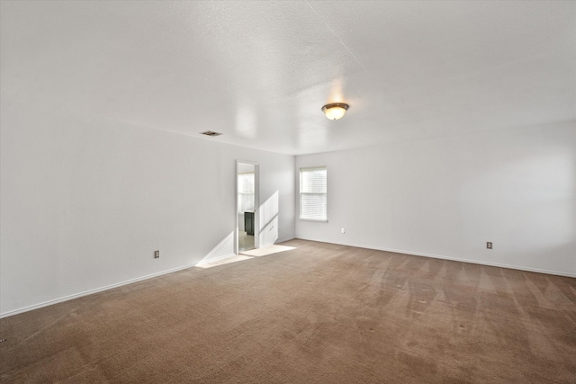 unfurnished room with light carpet