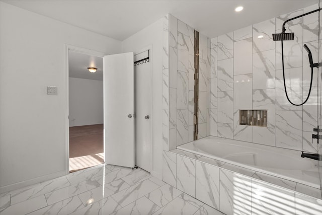 bathroom with tiled shower and vanity