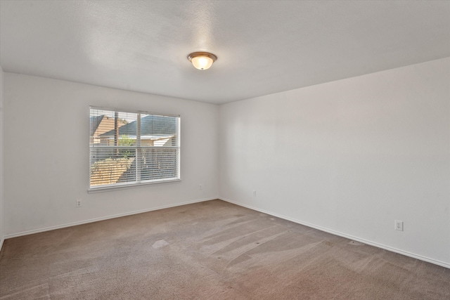 carpeted spare room featuring a textured ceiling