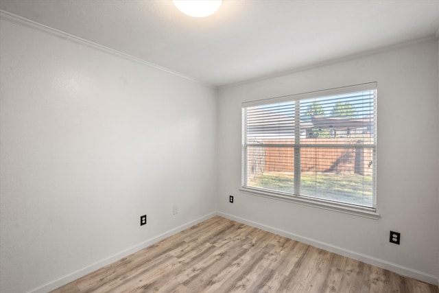 spare room featuring light hardwood / wood-style floors, ornamental molding, and sink