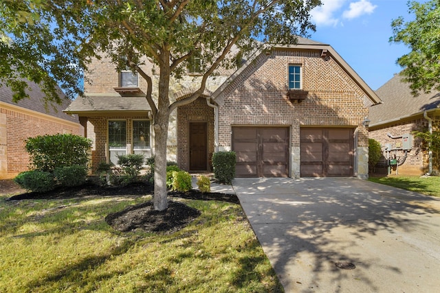 view of front of house featuring a garage and a front yard