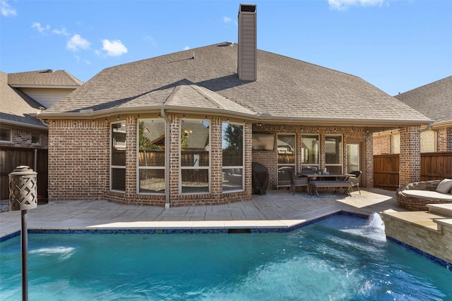 view of swimming pool with a patio and pool water feature