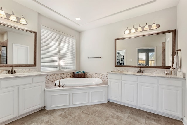 full bath with a garden tub, a sink, and a healthy amount of sunlight