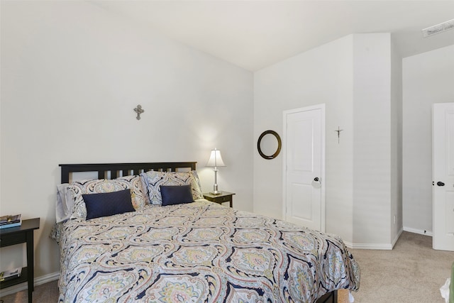 bedroom with light colored carpet, visible vents, and baseboards