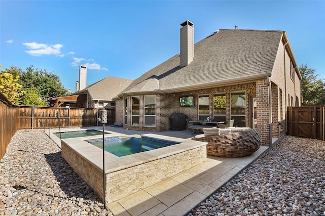 view of pool featuring a patio area, a fenced backyard, outdoor lounge area, and an in ground hot tub