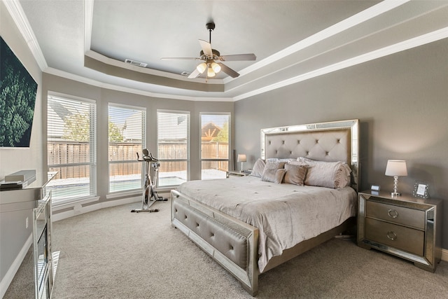 bedroom with visible vents, a raised ceiling, light colored carpet, ceiling fan, and ornamental molding