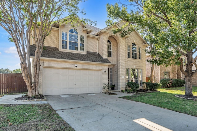 view of front of house with a front yard and a garage