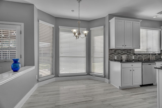 kitchen featuring dishwasher, pendant lighting, and a wealth of natural light