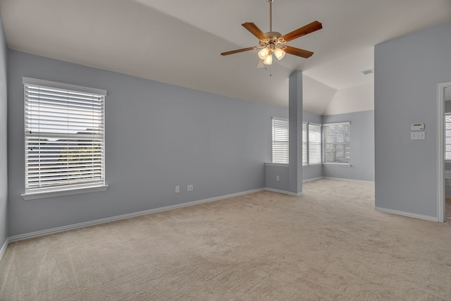 carpeted spare room featuring ceiling fan and lofted ceiling