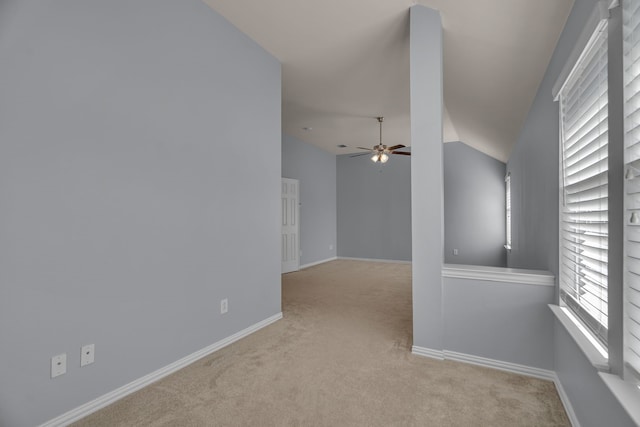 unfurnished room featuring light colored carpet, ceiling fan, and lofted ceiling