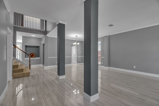 interior space featuring light wood-type flooring, ornamental molding, and a notable chandelier