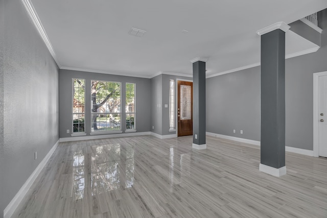 unfurnished living room featuring light hardwood / wood-style flooring, ornamental molding, and ornate columns