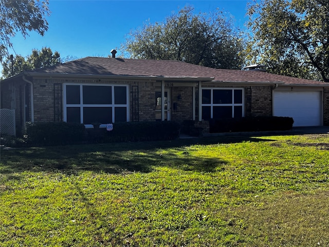 ranch-style house featuring a garage and a front yard