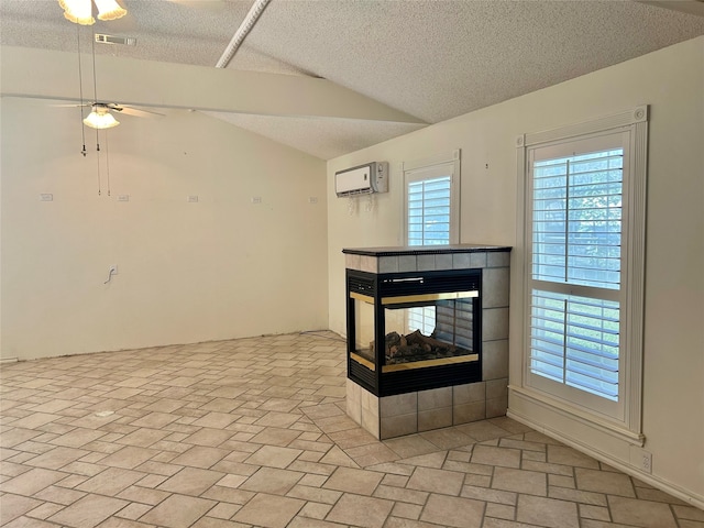 unfurnished living room with an AC wall unit, ceiling fan, a multi sided fireplace, and a textured ceiling