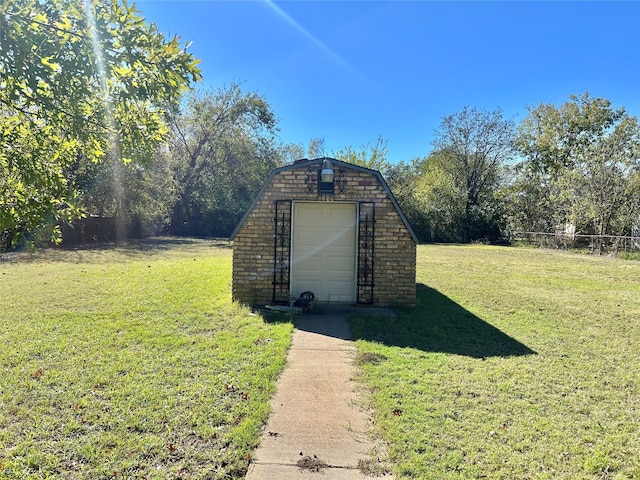 view of outbuilding featuring a lawn