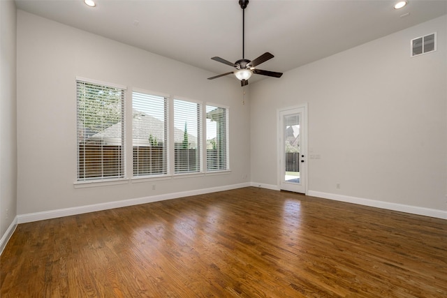 spare room with recessed lighting, dark wood finished floors, visible vents, and baseboards