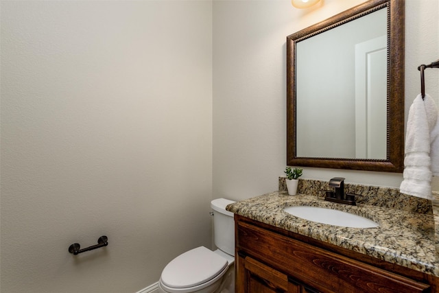 bathroom featuring toilet and vanity