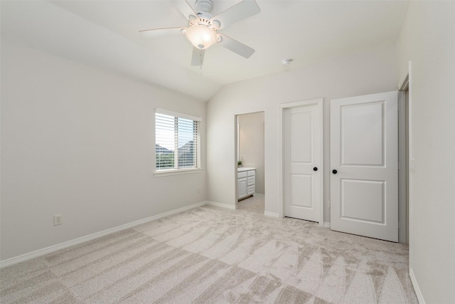 unfurnished bedroom with a ceiling fan, lofted ceiling, light carpet, and baseboards