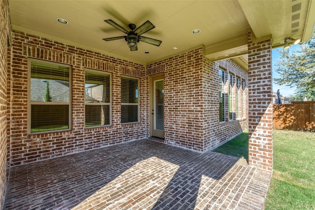 view of patio / terrace with ceiling fan and fence