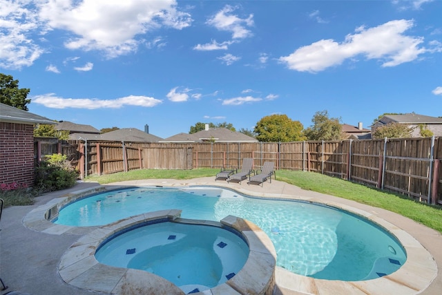 view of pool with a pool with connected hot tub, a fenced backyard, a lawn, and a patio