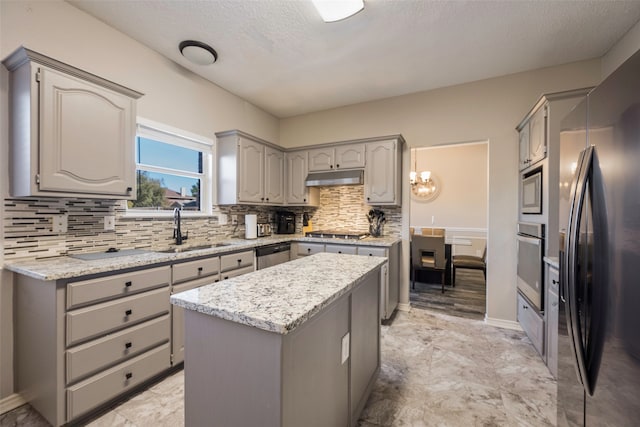 kitchen with gray cabinetry, sink, a center island, and appliances with stainless steel finishes