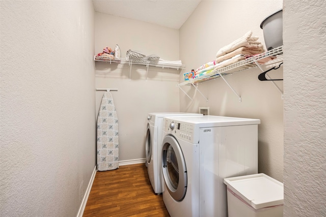 washroom with separate washer and dryer and dark wood-type flooring