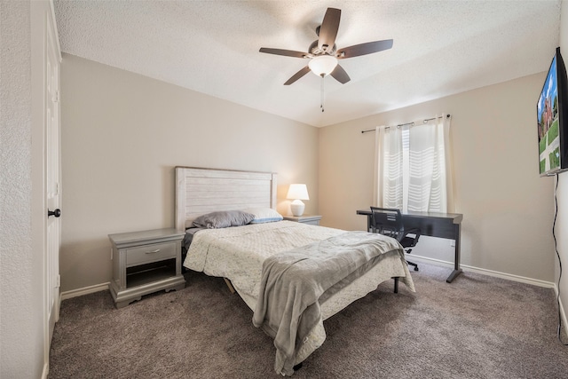 carpeted bedroom featuring ceiling fan and a textured ceiling