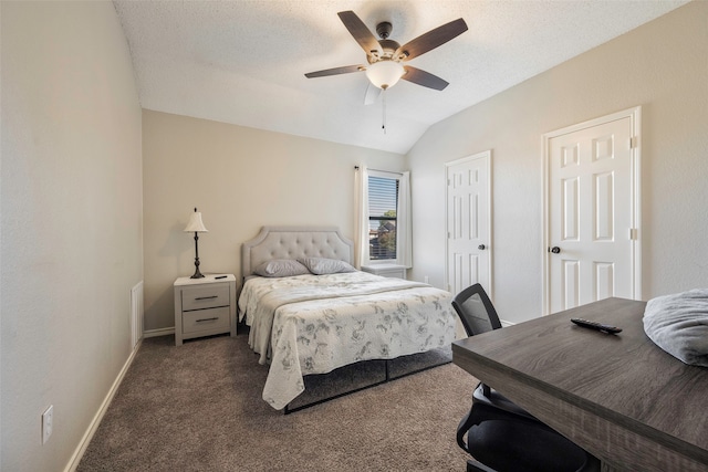 bedroom featuring ceiling fan, dark carpet, a textured ceiling, and vaulted ceiling