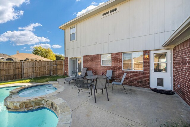 view of pool featuring an in ground hot tub, french doors, a patio, and a lawn