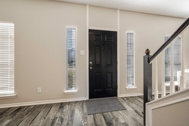 foyer entrance featuring wood-type flooring and a wealth of natural light