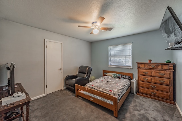 bedroom with dark colored carpet, a textured ceiling, and ceiling fan