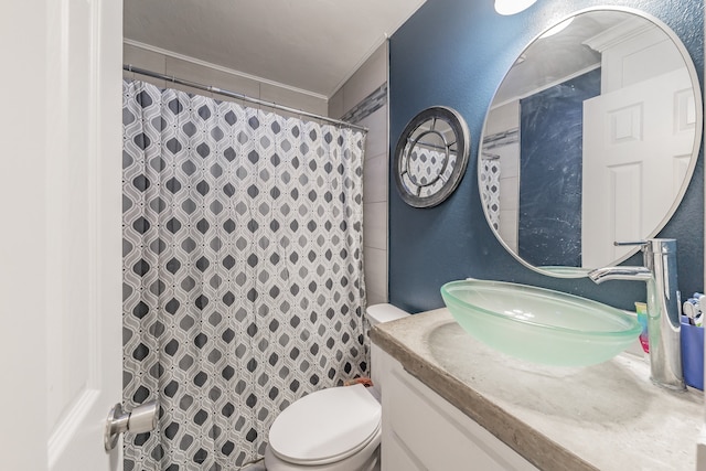 bathroom with vanity, toilet, and crown molding