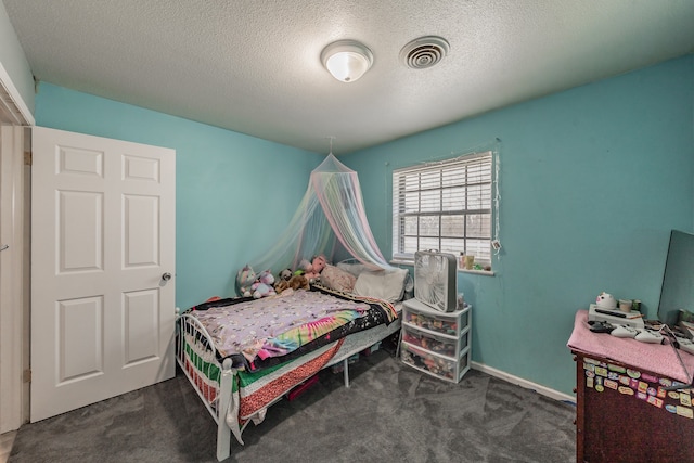 carpeted bedroom with a textured ceiling