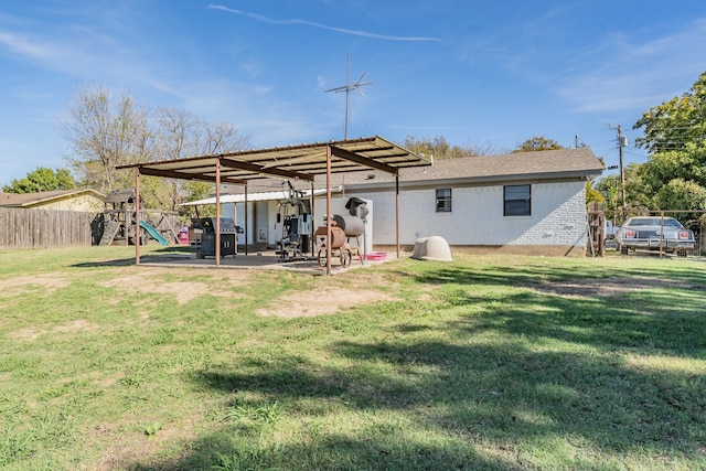 back of property with a playground and a yard