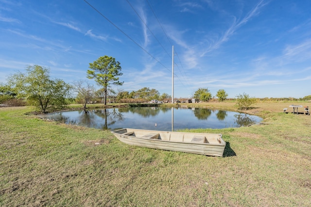 exterior space featuring a lawn and a water view